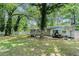 Beautiful backyard featuring mature trees and green space for outdoor activities and entertainment at 200 Robin Hood Ln, Hampton, GA 30228