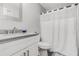 Clean bathroom featuring granite vanity and shower with curtain at 200 Robin Hood Ln, Hampton, GA 30228