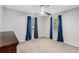 Cozy bedroom featuring plush carpeting and ample natural light from the windows at 200 Robin Hood Ln, Hampton, GA 30228