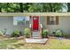 Welcoming home featuring a striking red front door and manicured shrubs along the front entrance at 200 Robin Hood Ln, Hampton, GA 30228