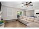 Cozy living area features wood-look flooring, fan, grey painted brick and lots of natural light at 200 Robin Hood Ln, Hampton, GA 30228