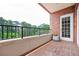 Cozy balcony with brick flooring, wrought iron railing and lush views of trees at 3657 Peachtree Ne Rd # 4A, Atlanta, GA 30319