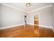 Bedroom with hardwood floors, neutral walls, white crown molding, and two entryways at 3657 Peachtree Ne Rd # 4A, Atlanta, GA 30319