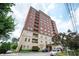 Upscale building with a mix of brick and stone, balconies, and well-maintained landscaping at 3657 Peachtree Ne Rd # 4A, Atlanta, GA 30319