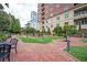 Beautiful courtyard with brick pathways, lush greenery, seating, and fountain at 3657 Peachtree Ne Rd # 4A, Atlanta, GA 30319