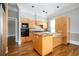 Bright kitchen features wooden cabinets, granite counters, modern appliances, and hardwood floors at 3657 Peachtree Ne Rd # 4A, Atlanta, GA 30319