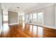 Open-concept living area with hardwood floors, neutral paint, and French doors to the balcony at 3657 Peachtree Ne Rd # 4A, Atlanta, GA 30319