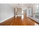 Spacious living room with gleaming hardwood floors, decorative columns and balcony access at 3657 Peachtree Ne Rd # 4A, Atlanta, GA 30319