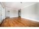 Sunlit living area with hardwood floors, neutral walls, and glass doors to a private balcony at 3657 Peachtree Ne Rd # 4A, Atlanta, GA 30319