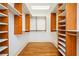Spacious walk-in closet featuring custom shelving, hardwood floors, and ample storage space at 3657 Peachtree Ne Rd # 4A, Atlanta, GA 30319
