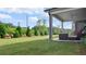 Lush green backyard with a covered patio area, mature landscaping, and a serene outdoor space at 3860 Oxford Park Ln, Cumming, GA 30040