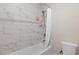 Bathroom featuring marble subway tile surround and shower-tub combo at 3860 Oxford Park Ln, Cumming, GA 30040