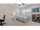Bedroom with a bright window, ceiling fan, and decorated with bookshelf and art at 3860 Oxford Park Ln, Cumming, GA 30040