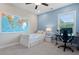 Bright bedroom with a single bed, computer desk, and colorful world map on the wall at 3860 Oxford Park Ln, Cumming, GA 30040