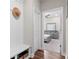 Hallway leading to Primary bedroom featuring neutral paint, bench with storage, and a hat at 3860 Oxford Park Ln, Cumming, GA 30040