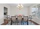 Elegant dining room with a large window and modern chandelier at 3860 Oxford Park Ln, Cumming, GA 30040