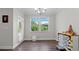 A bright dining room featuring a window, modern lighting, and neutral paint at 3860 Oxford Park Ln, Cumming, GA 30040