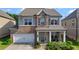 Charming two-story home with a brick facade and inviting front porch at 3860 Oxford Park Ln, Cumming, GA 30040