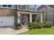 Inviting front porch with decorative columns and a stylish front door at 3860 Oxford Park Ln, Cumming, GA 30040