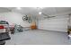 Garage with epoxy floor, treadmill, bikes, and overhead storage at 3860 Oxford Park Ln, Cumming, GA 30040