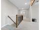 Hallway featuring carpet flooring and a wood-and-metal staircase railing at 3860 Oxford Park Ln, Cumming, GA 30040