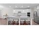 Beautiful kitchen island featuring white cabinets, granite countertops, and seating at 3860 Oxford Park Ln, Cumming, GA 30040