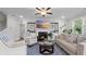Cozy living room featuring a fireplace, built-in shelves, and a ceiling fan at 3860 Oxford Park Ln, Cumming, GA 30040