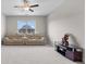 Living room featuring carpet, ceiling fan and view of backyard at 3860 Oxford Park Ln, Cumming, GA 30040