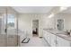 Bathroom features a glass shower, soaking tub, double vanity, tile floors and marble countertops at 3860 Oxford Park Ln, Cumming, GA 30040