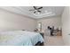 Bright bedroom features a trey ceiling, ceiling fan, and open doorway to the en-suite bathroom at 3860 Oxford Park Ln, Cumming, GA 30040