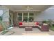 Covered patio featuring comfortable seating, ceiling fan, and stylish decor for outdoor enjoyment at 3860 Oxford Park Ln, Cumming, GA 30040
