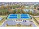 Aerial view of community tennis courts, parking and clubhouse next to a pond at 3860 Oxford Park Ln, Cumming, GA 30040