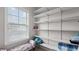 Bright walk-in closet featuring custom white shelves and bench seating at 3860 Oxford Park Ln, Cumming, GA 30040