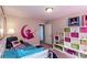 Charming bedroom with colorful decor, whimsical wall art, and plenty of storage space in the cubby shelves at 5110 Mulberry Pass Ct, Hoschton, GA 30548