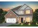 Charming two-story brick home with white trim, landscaped yard, and a two-car garage at 5110 Mulberry Pass Ct, Hoschton, GA 30548