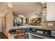 Partial view of a kitchen leading to the dinning area, showcasing a granite countertop at 5110 Mulberry Pass Ct, Hoschton, GA 30548