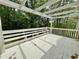 Outdoor deck overlooking a wooded lot with a wooden pergola at 610 Coolsprings Ln, Woodstock, GA 30188