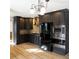 Modern kitchen featuring sleek, dark cabinets, stainless steel appliances, and stylish countertops, blending functionality with elegance at 610 Coolsprings Ln, Woodstock, GA 30188