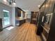 Well-lit kitchen featuring dark cabinetry, stainless steel appliances, and an adjacent outdoor deck at 610 Coolsprings Ln, Woodstock, GA 30188
