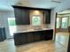 Updated kitchen has a stainless steel sink, granite countertops, and gray cabinets at 610 Coolsprings Ln, Woodstock, GA 30188