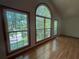 This bright living room features large windows with beautiful views of the outdoor landscape at 610 Coolsprings Ln, Woodstock, GA 30188