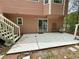 A view of the patio with white stairs leading down to it, and a sliding glass door leading into the house at 610 Coolsprings Ln, Woodstock, GA 30188
