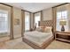 Cozy bedroom with plush carpet, a tufted headboard bed, and soft natural lighting, provides a serene and relaxing retreat at 150 Ray Way, Chattahoochee Hills, GA 30268