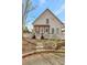 Exterior showcasing a well-maintained home with inviting front porch and landscaping at 150 Ray Way, Chattahoochee Hills, GA 30268