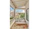 Inviting porch with brick floor and cozy swing, perfect for relaxing outdoors at 150 Ray Way, Chattahoochee Hills, GA 30268