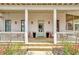 Welcoming front porch with classic details, featuring ample seating and inviting decor at 150 Ray Way, Chattahoochee Hills, GA 30268