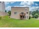 Exterior shot of the home with a deck overlooking the spacious backyard at 1727 Shire Village Dr, Sugar Hill, GA 30518