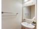 Half bath featuring a modern sink with a decorative mirror at 1727 Shire Village Dr, Sugar Hill, GA 30518