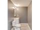 Bathroom featuring neutral walls, a white toilet, sink, and modern fixtures at 1727 Shire Village Dr, Sugar Hill, GA 30518