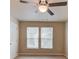 Bedroom featuring two windows providing natural light and ample closet space at 1727 Shire Village Dr, Sugar Hill, GA 30518